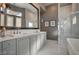 Elegant bathroom with double vanity, marble countertop, soaking tub, and glass-enclosed shower at 30 Via Tiberius Way, Henderson, NV 89011