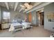 Charming bedroom featuring rustic wood beams, ample natural light, and two comfortable beds with blue and white linens at 30 Via Tiberius Way, Henderson, NV 89011