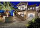 Elegant facade featuring a curved staircase ascending to a stylish entrance with double doors and stone accents at 30 Via Tiberius Way, Henderson, NV 89011
