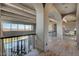 Gorgeous hallway with wood floors, beams, railing, and views of the pool and distant mountains at 30 Via Tiberius Way, Henderson, NV 89011