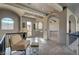 Bright hallway with arched doorways, wood flooring, and comfortable seating area at 30 Via Tiberius Way, Henderson, NV 89011