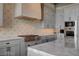 Gourmet kitchen featuring stainless steel appliances, gas range, and custom cabinetry at 30 Via Tiberius Way, Henderson, NV 89011