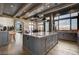Gourmet kitchen with gray cabinets, marble counters, and a large island at 30 Via Tiberius Way, Henderson, NV 89011