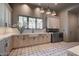 Bright laundry room with marble counters, shaker cabinets, and stainless steel washer and dryer at 30 Via Tiberius Way, Henderson, NV 89011