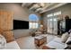 Comfortable living room with high ceilings, exposed wood beams, and flat screen tv at 30 Via Tiberius Way, Henderson, NV 89011