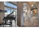 Living room with piano, light wood floors, and floor-to-ceiling windows offering views at 30 Via Tiberius Way, Henderson, NV 89011
