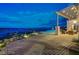 Expansive outdoor patio featuring a shaded seating area, an infinity pool, and panoramic views of the city at 30 Via Tiberius Way, Henderson, NV 89011
