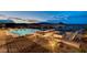 A luxurious infinity pool is surrounded by comfortable seating and a cozy fire pit, offering breathtaking city views at 30 Via Tiberius Way, Henderson, NV 89011