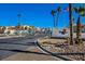 Community entrance featuring lush landscaping, palm trees, an American flag, and a welcoming gate at 3550 Bay Sands Dr # 2027, Laughlin, NV 89029