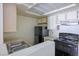 Efficient kitchen equipped with a black refrigerator and stove against light countertops at 3550 Bay Sands Dr # 2027, Laughlin, NV 89029