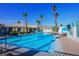 Inviting community pool with clear blue water, palm trees, and plenty of seating for residents and guests at 3550 Bay Sands Dr # 2027, Laughlin, NV 89029