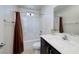 This bathroom has a shower-tub combo with shower curtain, white sink and toilet at 357 Stone Fly Rd, North Las Vegas, NV 89032