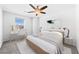 This bedroom has a ceiling fan and a desk and chair by the window at 357 Stone Fly Rd, North Las Vegas, NV 89032