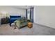 Bright bedroom features new carpet, gray walls, a Queen bed, and a small settee at 357 Stone Fly Rd, North Las Vegas, NV 89032