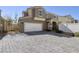 Charming home featuring a two-car garage and an inviting gray brick driveway at 357 Stone Fly Rd, North Las Vegas, NV 89032