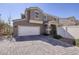 Two-story home featuring a wide driveway and a two-car garage at 357 Stone Fly Rd, North Las Vegas, NV 89032