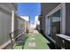 Private patio features lounge seating, umbrella, artificial grass and privacy fencing at 357 Stone Fly Rd, North Las Vegas, NV 89032