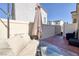 Private patio features lounge seating, umbrella, artificial grass and privacy fencing at 357 Stone Fly Rd, North Las Vegas, NV 89032