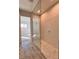 Modern bathroom with a glass-enclosed shower, pebble flooring, and wood look tile floors at 370 Haddocks Hall Pl, Henderson, NV 89011