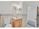 Bathroom with nautical-themed wallpaper, toilet and a single sink vanity with mirror and lighting at 3933 Lazy Pine St # 204, Las Vegas, NV 89108