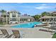 Community swimming pool with lounge chairs and covered lounge areas at 3933 Lazy Pine St # 204, Las Vegas, NV 89108