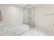 Bright and clean bathroom with a soaking tub, glass-enclosed shower, and marble tile at 4471 Dean Martin Dr # 2705, Las Vegas, NV 89103