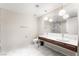 Modern bathroom featuring dual sinks, marble floors, and stylish lighting fixtures at 4471 Dean Martin Dr # 2705, Las Vegas, NV 89103