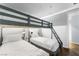 This bedroom includes gray bunkbeds with a ladder and stylish lighting at 4471 Dean Martin Dr # 2705, Las Vegas, NV 89103