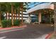 Elegant entrance to the building, with porte-cochere, landscaping, and circular driveway at 4471 Dean Martin Dr # 2705, Las Vegas, NV 89103