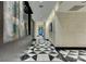 Hallway with decorative wall art and modern black and white geometric patterned flooring at 4471 Dean Martin Dr # 2705, Las Vegas, NV 89103