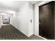 Long hallway leading to the apartment's door with carpet and white walls at 4471 Dean Martin Dr # 2705, Las Vegas, NV 89103