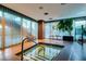 Relaxing indoor hot tub area with wood accents, sheer curtains and greenery at 4471 Dean Martin Dr # 2705, Las Vegas, NV 89103