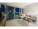 Inviting living room with a comfortable gray sectional, wood floors, and expansive windows with city views at 4471 Dean Martin Dr # 2705, Las Vegas, NV 89103