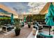 Stylish outdoor lounge area with comfortable seating, umbrellas, and gravel landscaping at 4471 Dean Martin Dr # 2705, Las Vegas, NV 89103