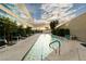 Outdoor lap pool with lounge seating, greenery, and skyline views at 4471 Dean Martin Dr # 2705, Las Vegas, NV 89103