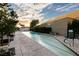 Outdoor lap pool with lounge seating, greenery, and skyline views at 4471 Dean Martin Dr # 2705, Las Vegas, NV 89103