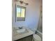 Bathroom with white countertop sink, matching toilet, and tiled shower stall with glass door at 4480 Annie Oakley Dr, Las Vegas, NV 89121
