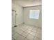 Bedroom featuring tile floors, a window with blinds, a floor lamp, and painted walls at 4480 Annie Oakley Dr, Las Vegas, NV 89121