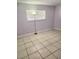 Bedroom featuring tile floors, a window with blinds, a floor lamp, and painted walls at 4480 Annie Oakley Dr, Las Vegas, NV 89121