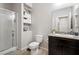 Functional bathroom featuring a granite countertop, vanity, toilet, and glass-enclosed shower, optimizing space and convenience at 4519 Stardusk Falls Ave, North Las Vegas, NV 89084