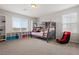 Spacious bedroom with a bunk bed, built-in shelving, and large windows offering natural light at 4519 Stardusk Falls Ave, North Las Vegas, NV 89084