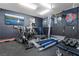 Well-equipped home gym featuring a variety of exercise machines and free weights for a complete workout at 4519 Stardusk Falls Ave, North Las Vegas, NV 89084