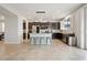 Open-concept kitchen with dark cabinetry, stainless steel appliances, and a center island with seating at 4519 Stardusk Falls Ave, North Las Vegas, NV 89084