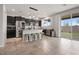 Modern kitchen boasts stainless steel appliances, dark cabinets, island seating, and seamless outdoor access at 4519 Stardusk Falls Ave, North Las Vegas, NV 89084
