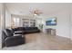 Comfortable living room with leather sectional sofa, media console, and ample natural light at 4519 Stardusk Falls Ave, North Las Vegas, NV 89084