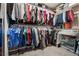 Walk-in closet well-organized, and featuring tiered hanging racks and shelf storage solutions for optimal space utilization at 4519 Stardusk Falls Ave, North Las Vegas, NV 89084