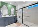 Modern bathroom featuring dual sinks and a glass-enclosed shower at 4567 Chirping Cricket Ave, Las Vegas, NV 89141