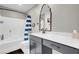 Well-lit bathroom with a sleek vanity, decorative mirror, and shower-tub combo at 4567 Chirping Cricket Ave, Las Vegas, NV 89141