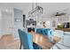 Inviting dining area adjacent to the kitchen and living room, showcasing modern lighting and comfortable seating at 4567 Chirping Cricket Ave, Las Vegas, NV 89141