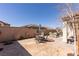 Spacious backyard featuring a stone patio, outdoor seating, and mature landscaping for privacy and shade at 472 Cadence View Way, Henderson, NV 89011